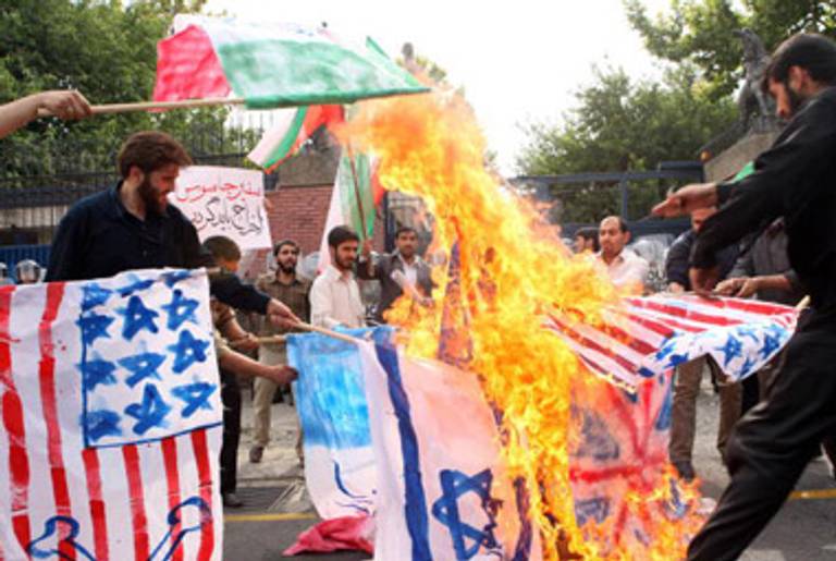 Students burn mock flags in a protest outside the British Embassy in Tehran yesterday.(AFP/Getty Images)