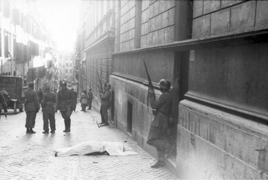 A body lies in the via Rasella in Rome on March 23, 1944, surrounded by German and Italian Fascist soldiers, after a partisan attack.(Deutsches Bundesarchiv via Wikimedia Commons)