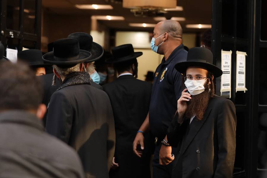 People gather outside of the Congregation Yetev Lev D’Satmar synagogue, along with members of the NYPD, in Brooklyn’s Williamsburg neighborhood on Oct. 19, 2020