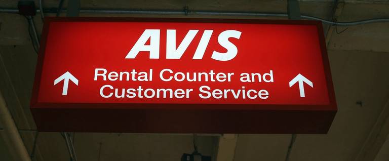 A sign hangs in an Avis rental car branch in Manhattan, January 2, 2013. 