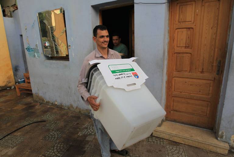 An empty ballot box this morning and a grinning bearer.(Mahmud Hams/AFP/GettyImages)