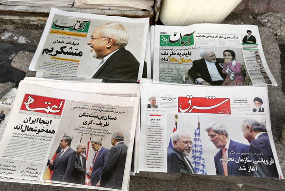 Iranians newspapers headlining the deal made with major powers over Iran's disputed nuclear deal are displayed on the ground outside a kiosk in Tehran on November 25, 2013. (ATTA KENARE/AFP/Getty Images)