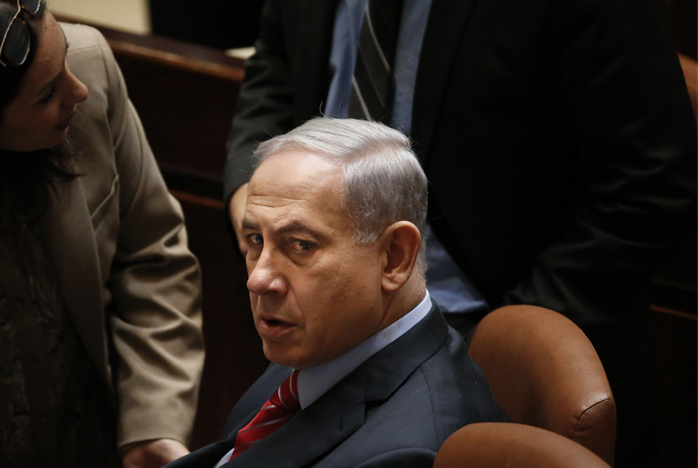 Israeli Prime Minister Benjamin Netanyahu listens to his advisers during the vote to dissolve the Knesset on Dec. 3, 2014, in Jerusalem.(Thomas Coex/AFP/Getty Images)