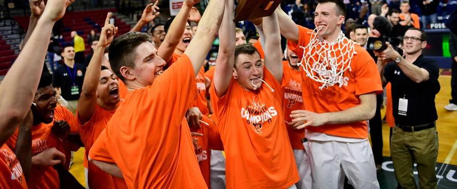 Spencer Weisz #10 (C) of the Princeton Tigers is the first to hoist the trophy for the crowd after the win against the Yale Bulldogs in the Ivy League tournament final at The Palestra on March 12, 2017 in Philadelphia, Pennsylvania. Princeton won 71-59. 
