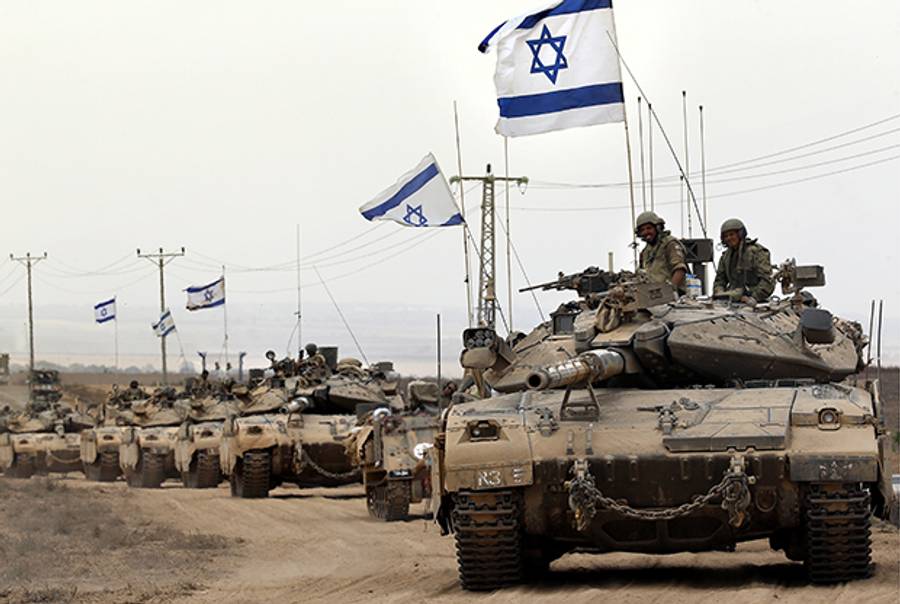 Israeli Merkava tanks drive near the border between Israel and the Gaza Strip as they return on August 5, 2014, after Israel announced that all of its troops had withdrawn from the Gaza Strip. (THOMAS COEX/AFP/Getty Images)