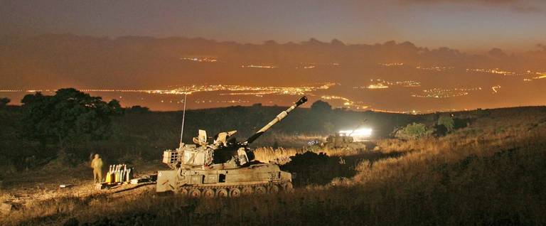 An Israeli mobile artillery unit prepares to fire 155mm shells towards Hezbollah targets in southern Lebanon, July 13, 2006, at a military staging area along the northern Israeli border with Lebanon.