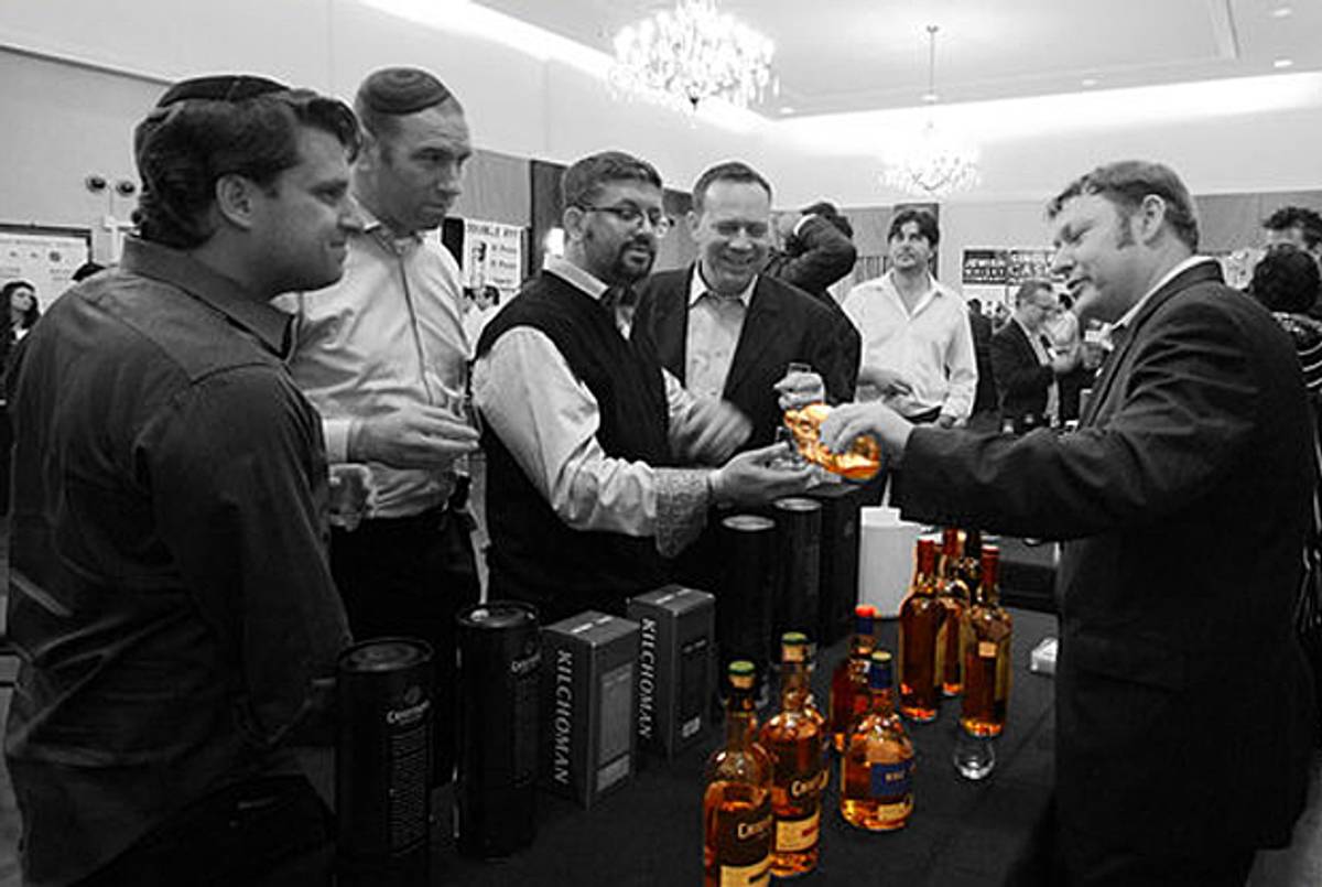Jared Card pours Arran and Kilchoman single malts at Whisky Jewbilee 2012.(Whiskey Jewbilee )