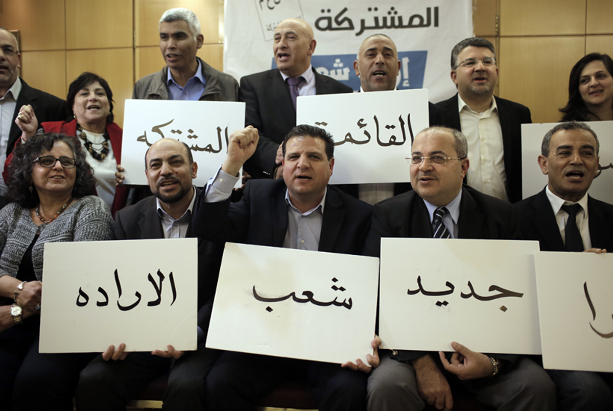 Israeli Arab political leaders (front row from L to R) Aida Tuma, Masud Ghanayem, Ayman Odeh, Ahmad Tibi, Jamal Zahalka pose for a photo holding placards bearing text in Arabic meaning 'Go to vote for the Joint List, for a new tomorrow on March 17' in Nazareth, Feb. 24, 2015.(Ahmad Gharabli/AFP/Getty Images)