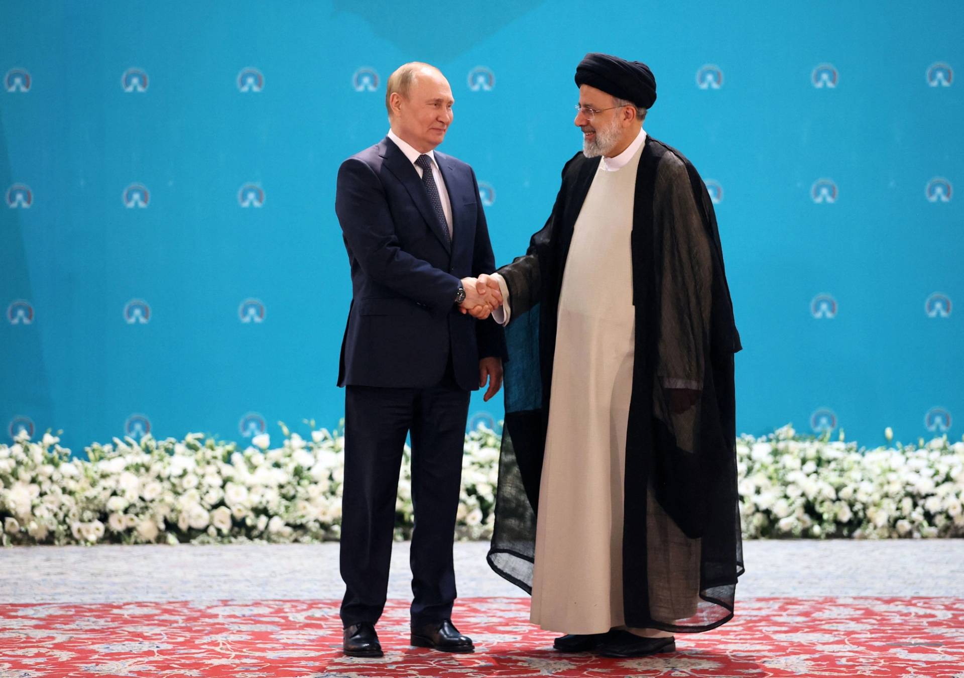 Iranian President Ebrahim Raisi greets Russian President Vladimir Putin before a trilateral meeting on Syria with Turkish President Recep Tayyip Erdogan in Tehran on July 19, 2022