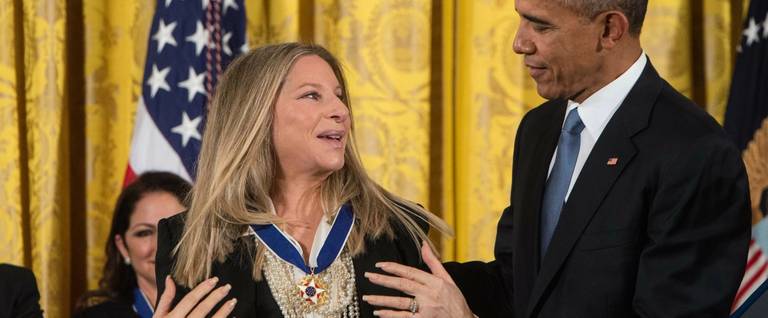 President Barack Obama presents the Presidential Medal of Freedom to singer and actress Barbra Streisand at the White House in Washington, DC, November 24, 2015. 
