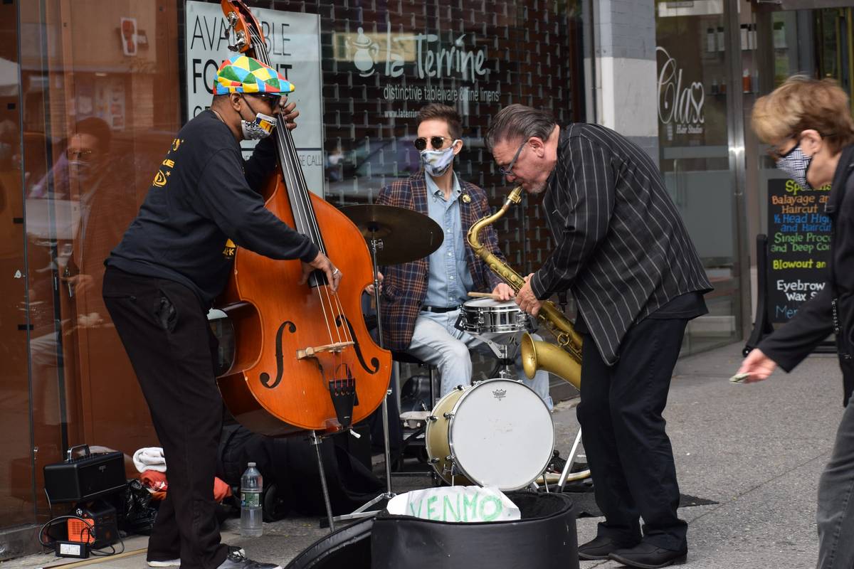 Evan Sherman, on drums, Tyler Mitchell, on bass, and Jerry Weldon, on sax, during an outdoor performance, New York City, fall 2020 