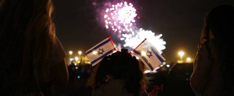 Israelis watch fireworks in the sky over Mount Herzl at the end of Israel's Memorial Day and at the start of Israel's 69th Independence Day celebrations, in Jerusalem late on May 1 2017.