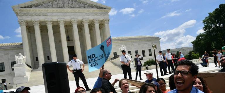 People protest the travel-ban decision outside of the U.S. Supreme Court in Washington, D.C. on June 26, 2018.