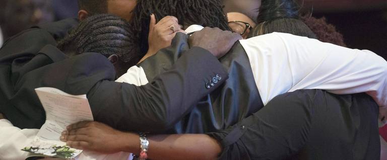 The grandchildren of Emanuel AME Church shooting victim, Ethel Lance, hug after delivering remarks at her funeral at the Royal Missionary Baptist Church in North Charleston, SC, June 25, 2015. 