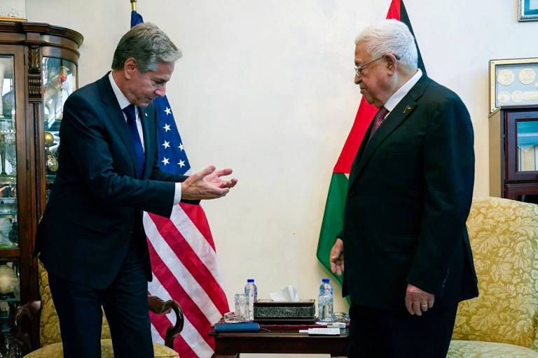 U.S. Secretary of State Antony Blinken, left, speaks with Palestinian President Mahmoud Abbas during a meeting in Amman on Oct. 13, 2023