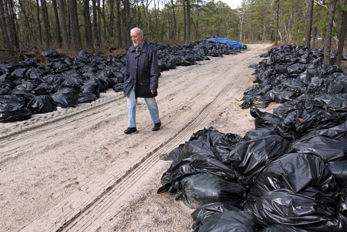 Larry Simons of Lakewood, N.J., walks along bags of religious articles, shaimos, unearthed off Vermont Avenue in February. Rabbi Chaim Abadi buried tons and tons of religious articles illegally off a dirt road that extends off Vermont Avenue.(Courtesy of The Asbury Park Press)