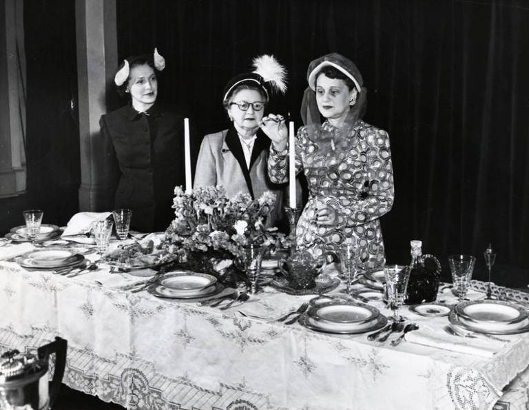 Mt. Zion Women’s Sisterhood members looking at a Shabbat dinner table setting