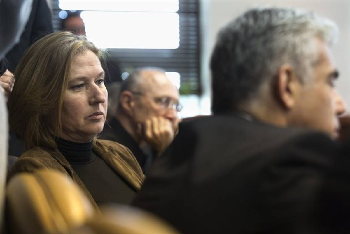 Israeli Justice Minister Tzipi Livni (L) and Finance Minister Yair Lapid (R) listen to Prime Minister Benjamin Netanyahu (unseen) during the weekly cabinet meeting at the latter's office in Jerusalem on November 23, 2014. Ministers were to discuss a controversial bill to anchor in law Israel's status as the national homeland of the Jewish people.(JIM HOLLANDER/AFP/Getty Images)
