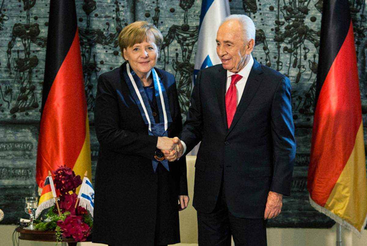 German Chancellor Angela Merkel shakes hands with Israeli President Shimon Peres after receiving the Presidential Medal of Distinction she recieved from during a ceremony at Israeli President's residence on February 25, 2014 in Jerusalem, Israel. (Ilia Yefimovich/Getty Images)
