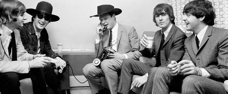 Brian Epstein using an antique phone given to him as a birthday gift by The Beatles.