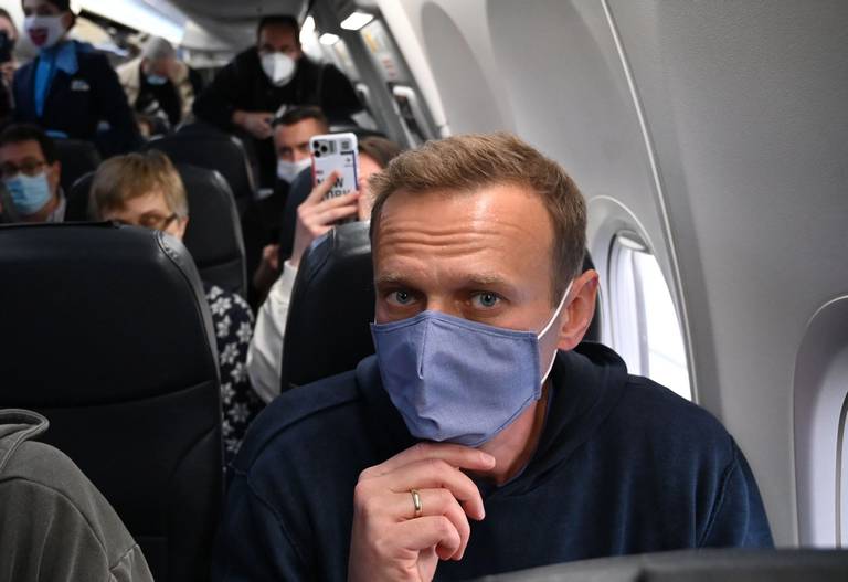 Russian opposition leader Alexei Navalny sits in a Pobeda airlines plane heading to Moscow before takeoff from Berlin Brandenburg Airport on Jan. 17, 2021