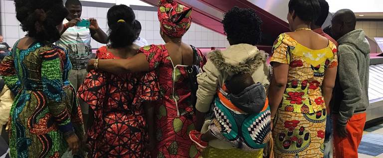 Members of a Congolese family await their baggage after arriving in Pittsburgh.