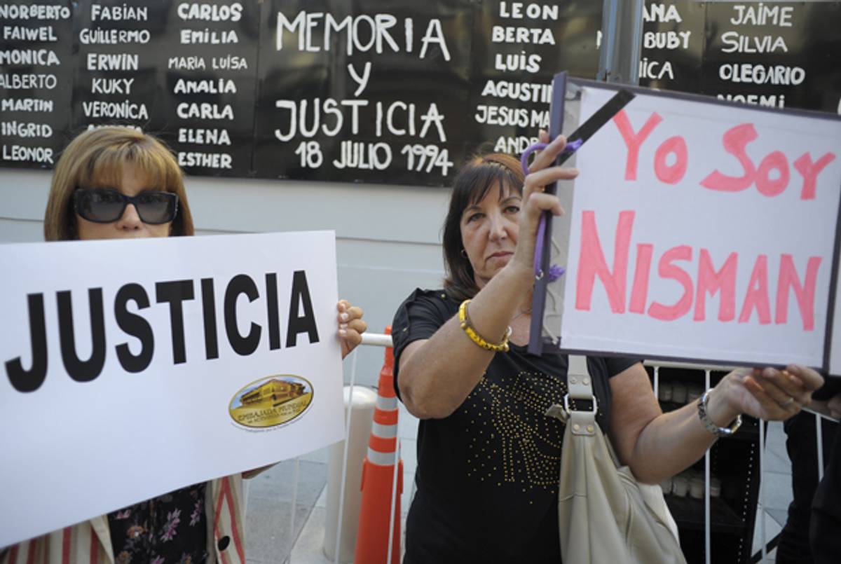 Women hold placards that read 'Justice' and 'I Am Nisman' during a rally in front of the headquarters of the Argentine Israelite Mutual Association), in Buenos Aires on January 21, 2015, to protest against the death of Argentine public prosecutor Alberto Nisman. (ALEJANDRO PAGNI/AFP/Getty Images)
