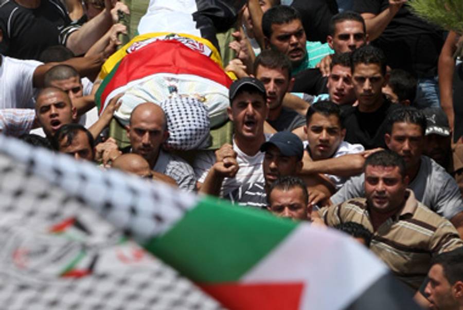 Victims of the firefight outside Ramallah are paraded through the streets this morning.(Abbas Momani/AFP/Getty Images)