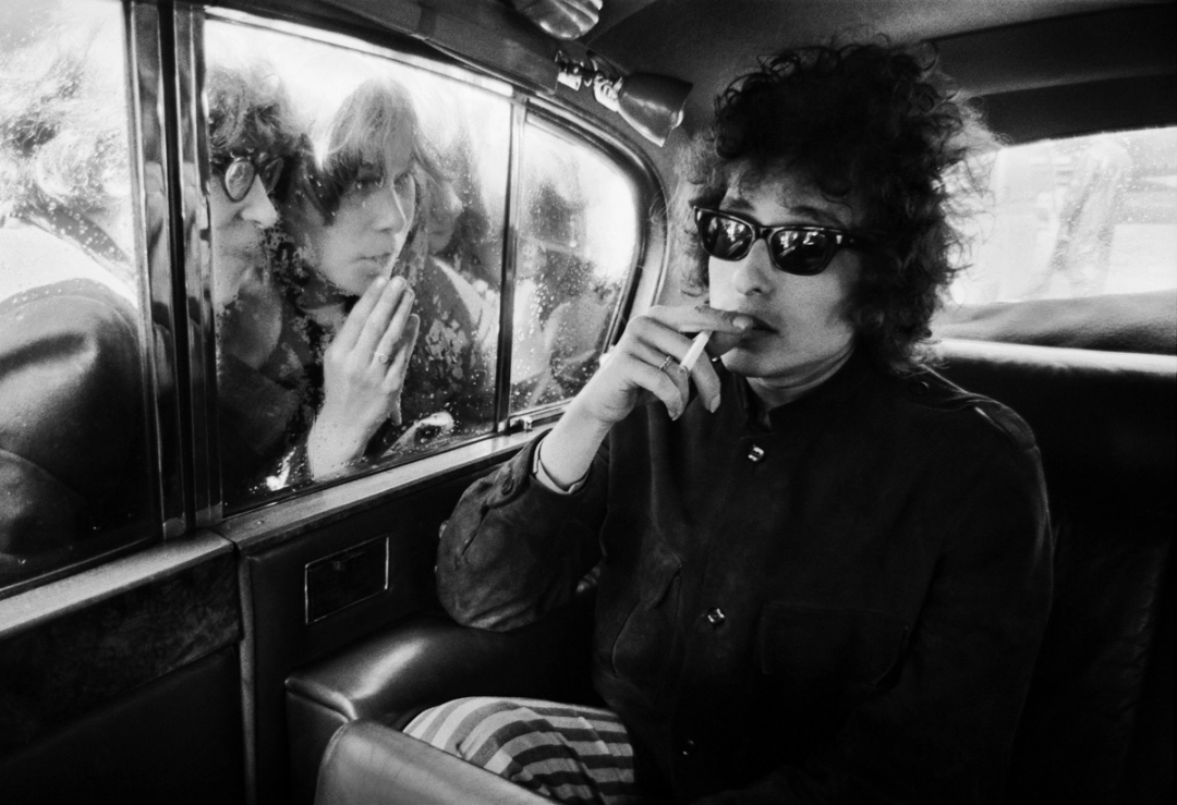 ‘Bob Dylan, Fans Looking in Limo, London, 1966.’ In May of 1966, as photographer Barry Feinstein and Bob Dylan (along with Dylan’s manager, Albert Grossman) rode into London’s Royal Albert Hall, a crush of screaming fans descended on the car. Feinstein captured Dylan keeping his cool. He also shot the portrait that Dylan used on the cover of the seminal 1964 album ‘The Times They Are A-Changin’.’
