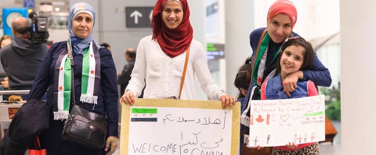 The first Syrian refugees are welcomed at Toronto's Pearson International Airport on December 10, 2015.