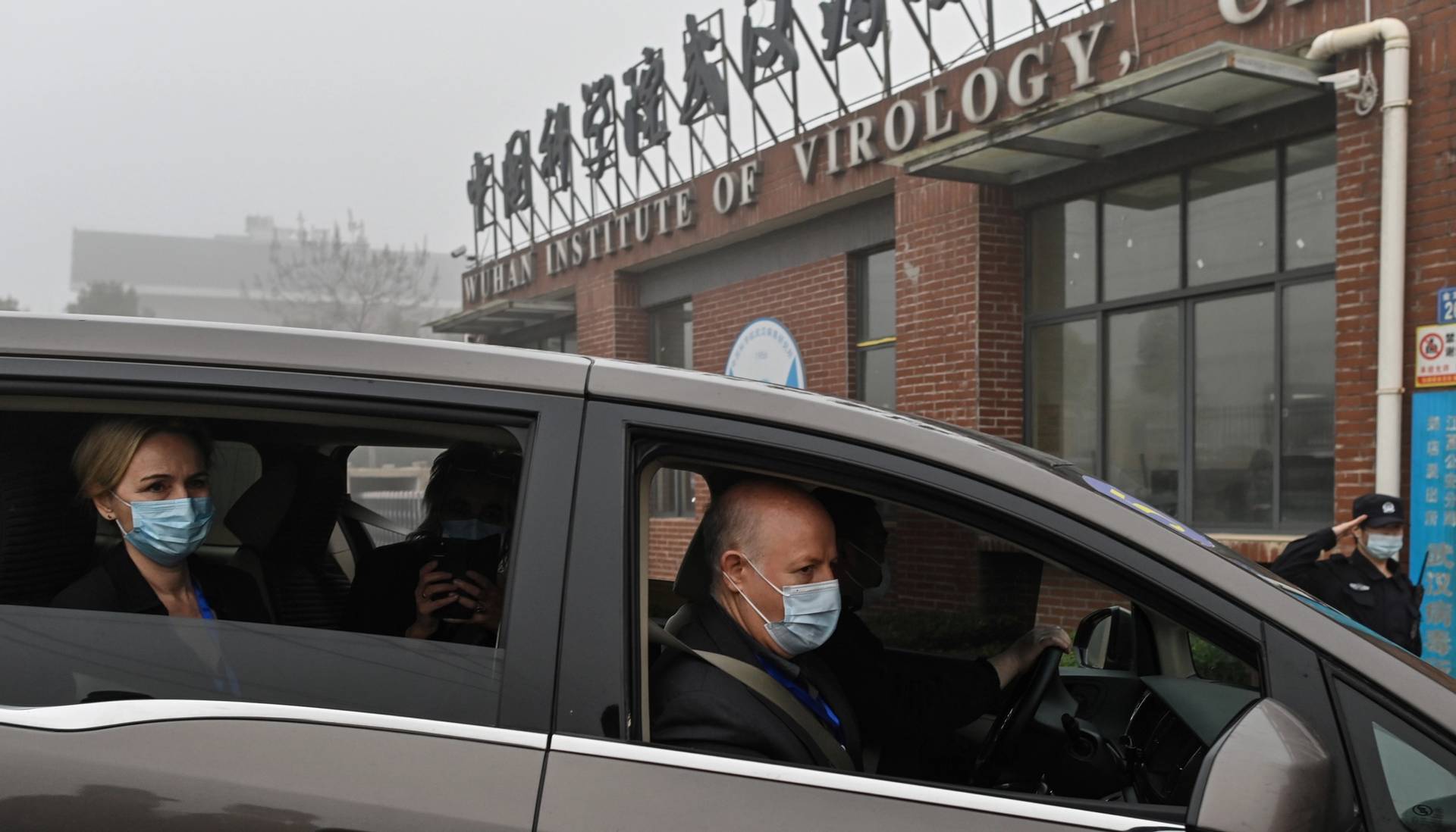 Peter Daszak, right, Thea Fischer, left, and other members of the World Health Organization team investigating the origins of COVID-19 arrive at the Wuhan Institute of Virology in China’s central Hubei province on Feb. 3, 2021