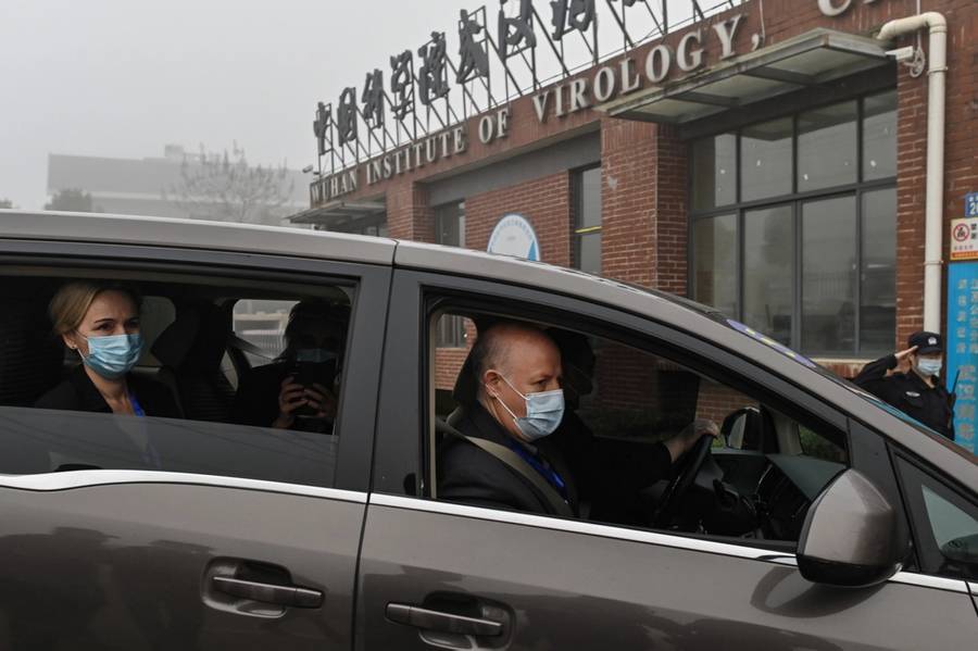 Peter Daszak, right, Thea Fischer, left, and other members of the World Health Organization team investigating the origins of COVID-19 arrive at the Wuhan Institute of Virology in China’s central Hubei province on Feb. 3, 2021