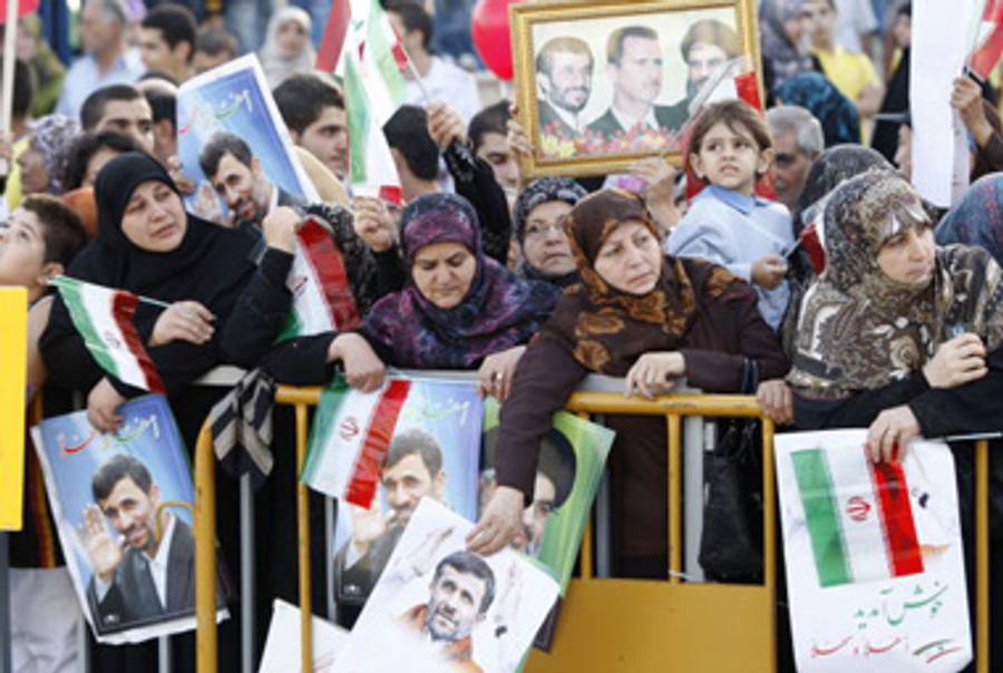 Lebanese well-wishers await President Ahmadinejad yesterday.(Salah Malkawi/Getty Images)