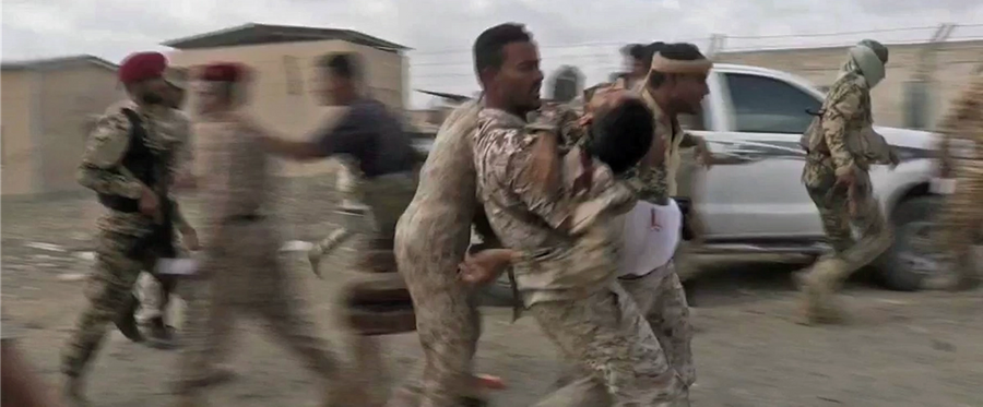 An image grab taken from a video obtained by AFPTV shows a wounded Yemeni soldier being carried by comrades after a drone exploded in the government-held southern province of Lahij on Jan. 10, 2019. 