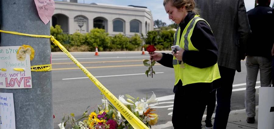 Flowers and signs at a makeshift memorial across from the Chabad of Poway synagogue on April 28, 2019.