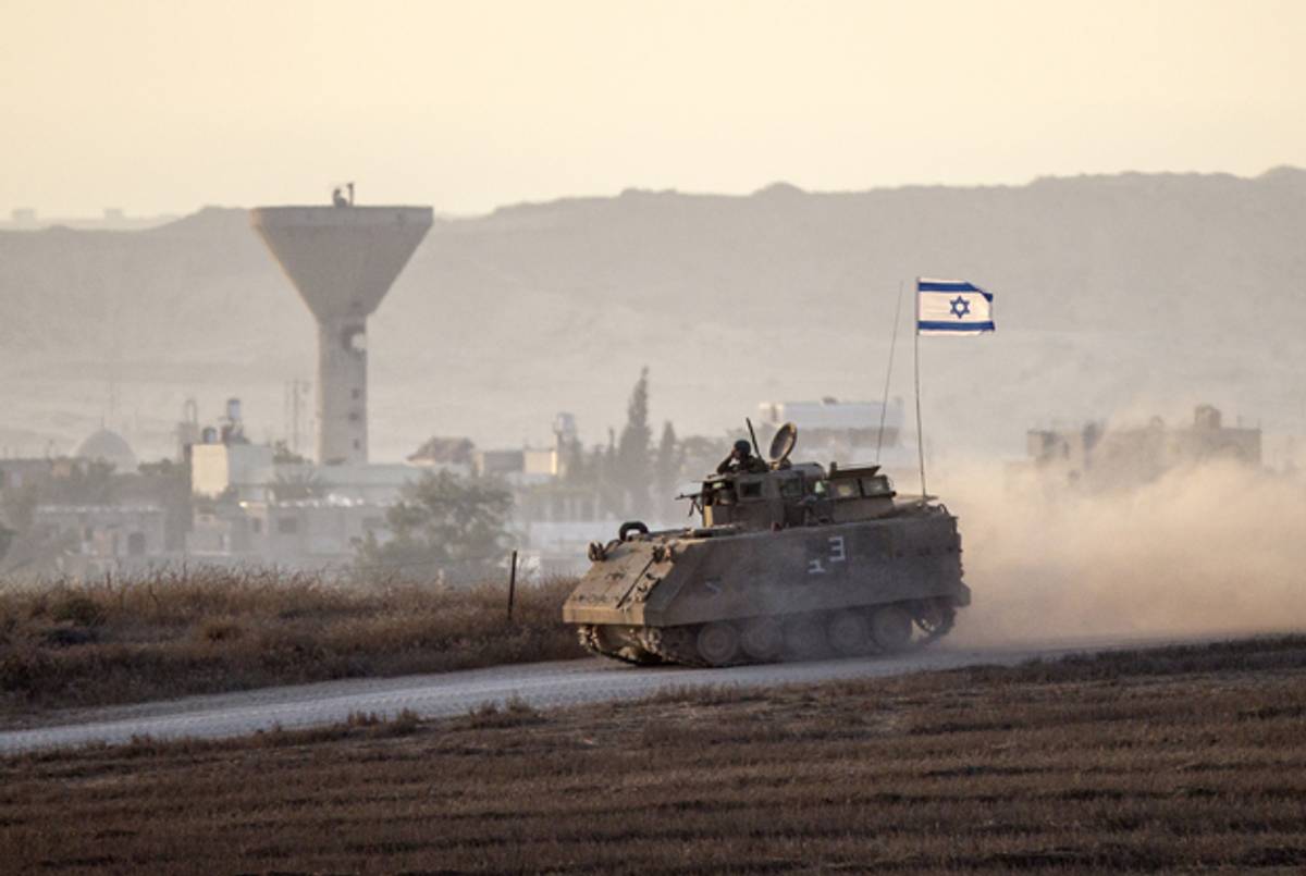 An Israeli army armoured personnel carrier drives along Israel's border with the Hamas-controlled Gaza Strip on August 4, 2014. (JACK GUEZ/AFP/Getty Images)