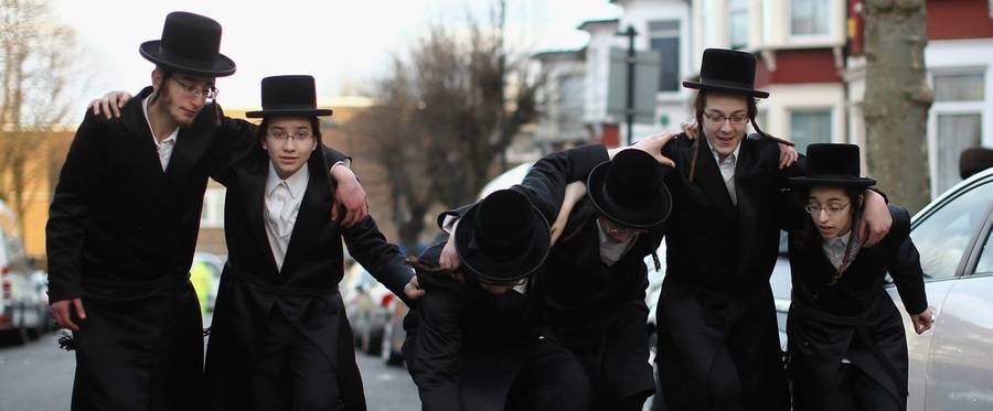 A group of Orthodox Jewish boys dance in the street during Purim in London, England, March 5, 2015. 