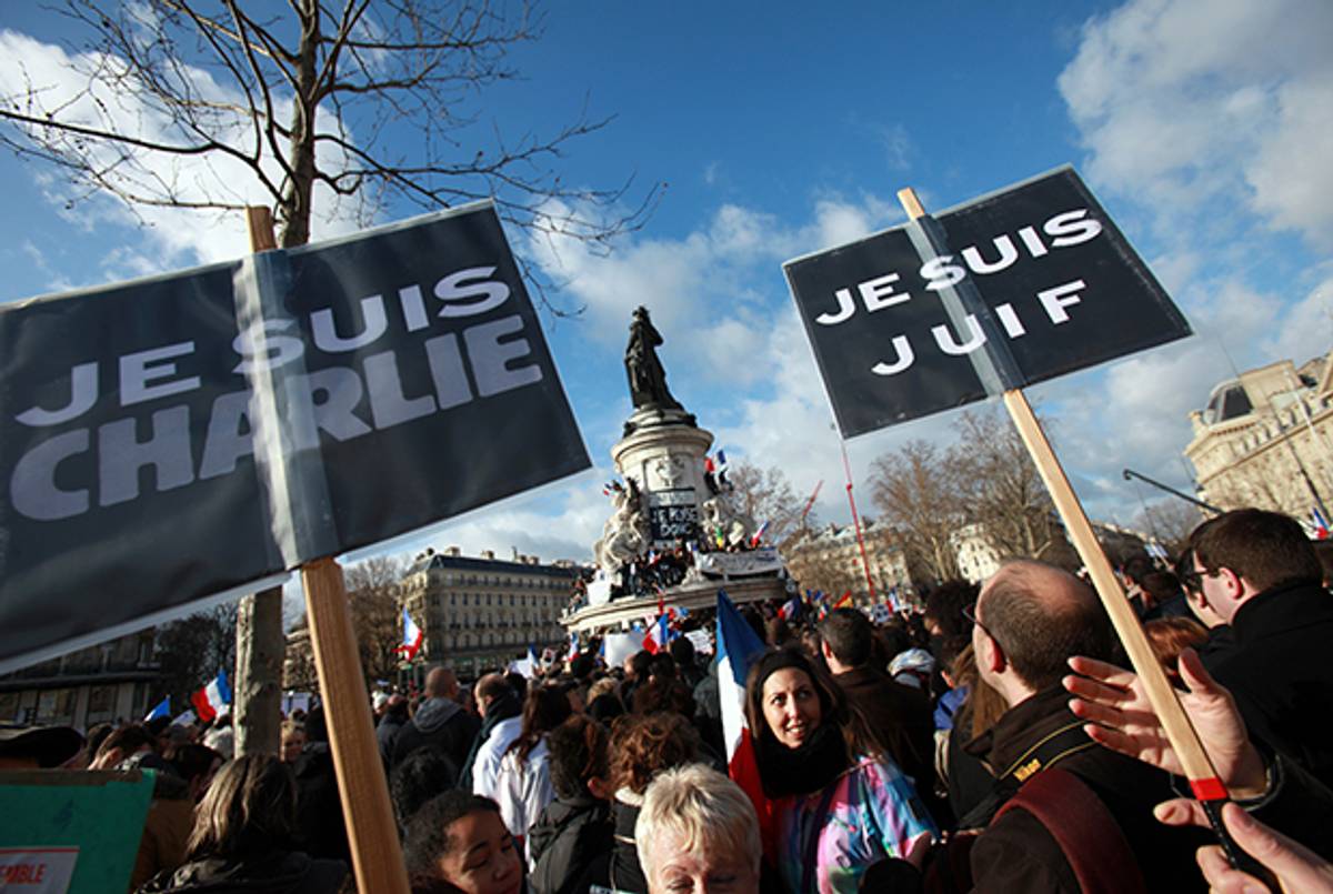 People hold banners reading 'I am Charlie' and 'I am Jewish' during a Unity rally Marche Republicaine on January 11, 2015 at the Place de la Republique in Paris. (LOIC VENANCE/AFP/Getty Images)