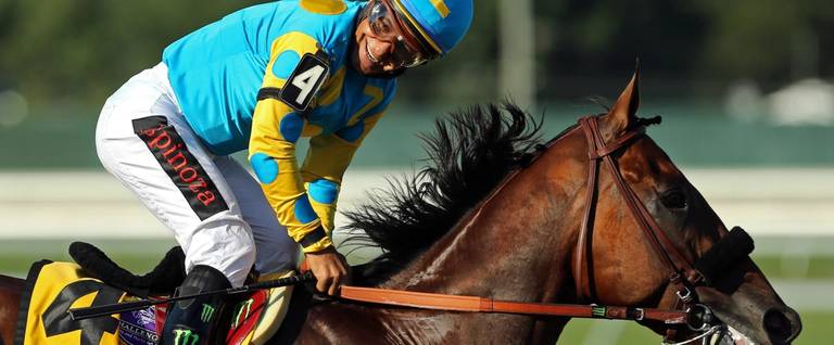 Victor Espinoza, atop American Pharoah (#4), reacts after winning the 48th William Hill Haskell Invitational at Monmouth Park in Monmouth, New Jersey, August 2, 2015.  