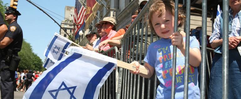 Malky Aschendorf, 3, of Queens, New York, waves an Israeli flag as she watches participants in the annual Salute to Israel Parade marching on May 31, 2009 in New York City.