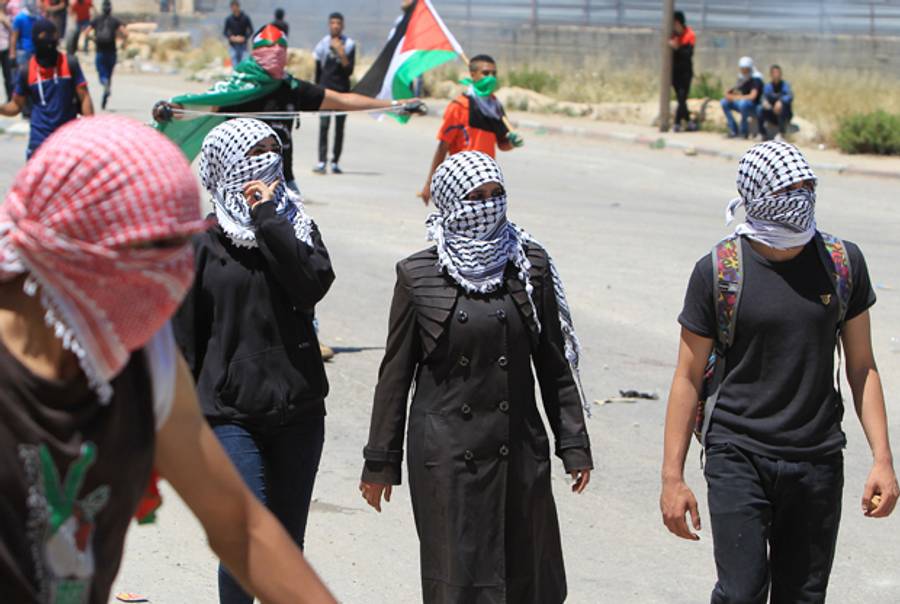Masked Palestinian protestors outside the Israeli-run Offer prison in the West Bank on May 15, 2014. (ABBAS MOMANI/AFP/Getty Images)