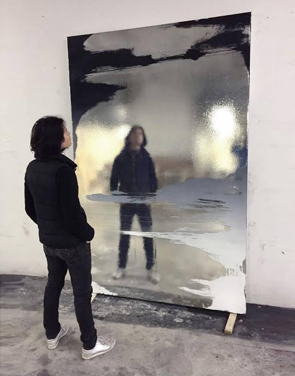 Hod standing in front of his creation, “Nothing is more narcotic than the past.” (Paint under chromed canvas)