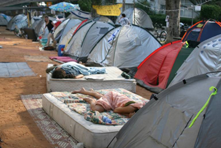 The activists wake up sprawled on mattresses on Rothschild Boulevard on Wednesday, July 27.(Daniella Cheslow)