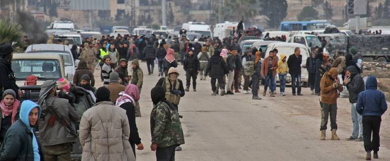 Syrian rebel fighters and civilians who were evacuated from rebel-held neighborhoods in the embattled city of Aleppo arrive in the opposition-controlled Khan al-Aassal region, west of Aleppo, December 16, 2016. 