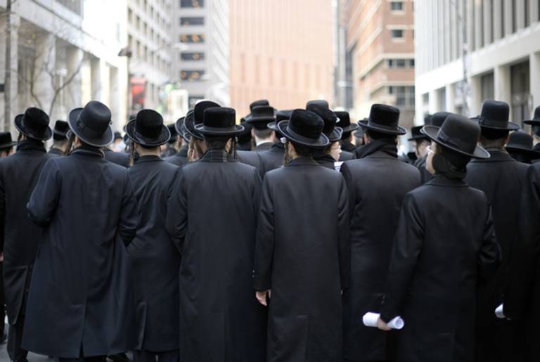 Orthodox Jews gather on Water Street in lower Manhattan March 9, 2014 to pray and protest against the current effort by the Israeli government to pass a law to draft religious Jews into its army. (TIMOTHY A. CLARY/AFP/Getty Images)