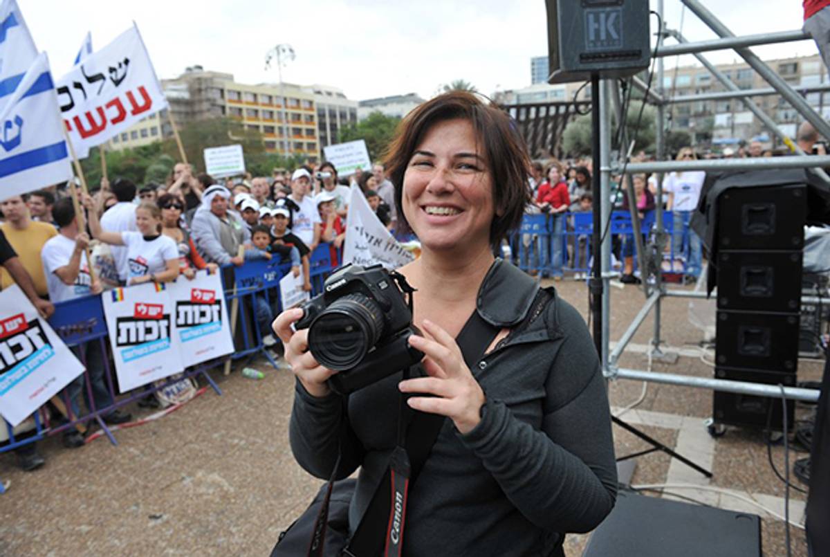 The author with her SLR camera at a protest in Tel Aviv. (Photo courtesy of the author)
