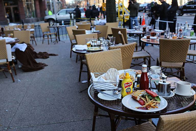 The unfinished meals of fleeing customers are left on tables at an outdoor restaurant near the scene of a twin bombing at the Boston Marathon on April 16, 2013 in Boston, Massachusetts.(Spencer Platt/Getty Images)