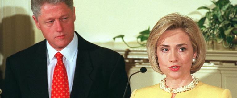 First Lady Hillary Clinton delivers a speech as her husband President Bill Clinton listens.