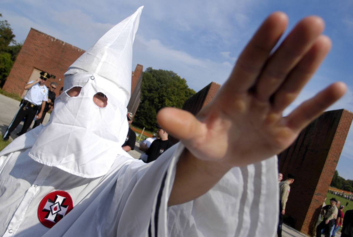 A member of the Ku Klux Klan salutes during an American Nazi Party rally on September 25, 2004 in Valley Forge, Pennsylvania. (William Thomas Cain/Getty Images)
