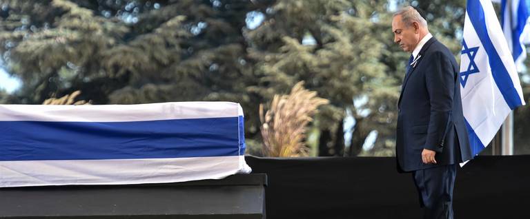 Israeli Prime Minister Benjamin Netanyahu pauses before the coffin of former Israeli president and prime minister Shimon Peres during his funeral at Mount Herzl national cemetery in Jerusalem, September 30, 2016. 